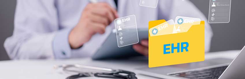 Specialist using digital tablet with EHR folder icon and medical records floating above laptop, representing electronic health records and modern healthcare technology concept.