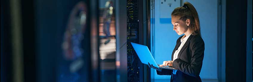 Female engineer working in server room at modern data center stock photo