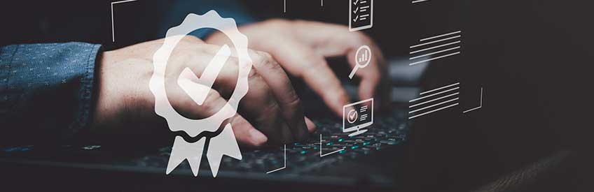 Businessman using keyboard. Certification icon overlaid in foreground. 