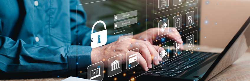 Businessman using keyboard with security icon in foreground. 