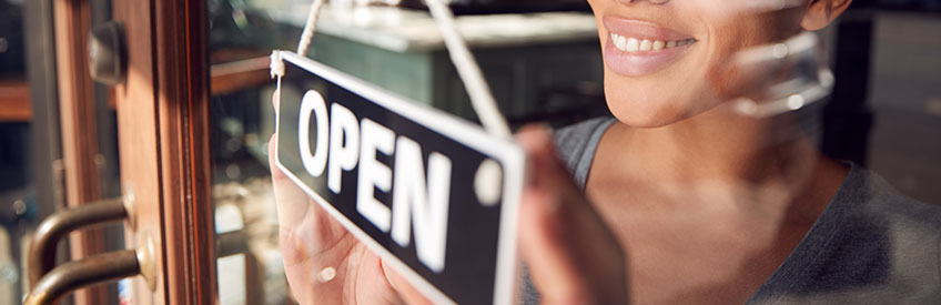 Business Owner with Open signage