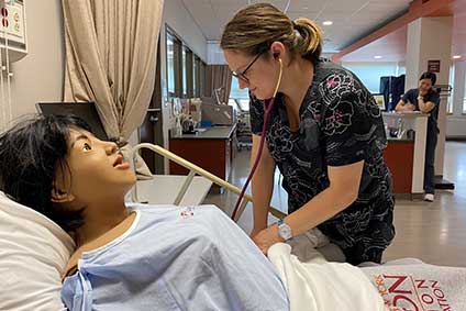 Nursing student with mannequin