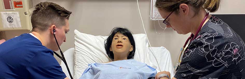 Two students working with mannequin 