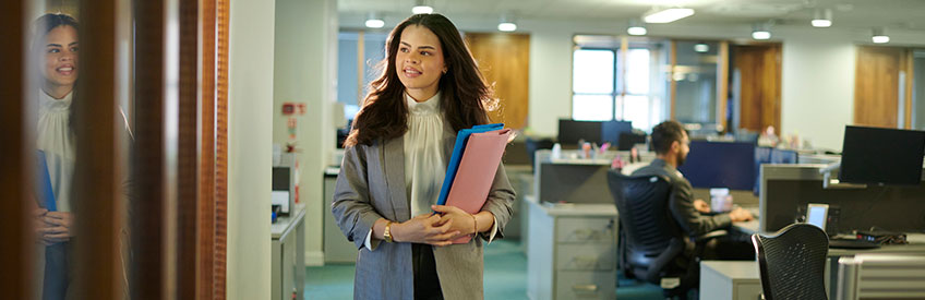 Paralegal walking and smiling in office setting
