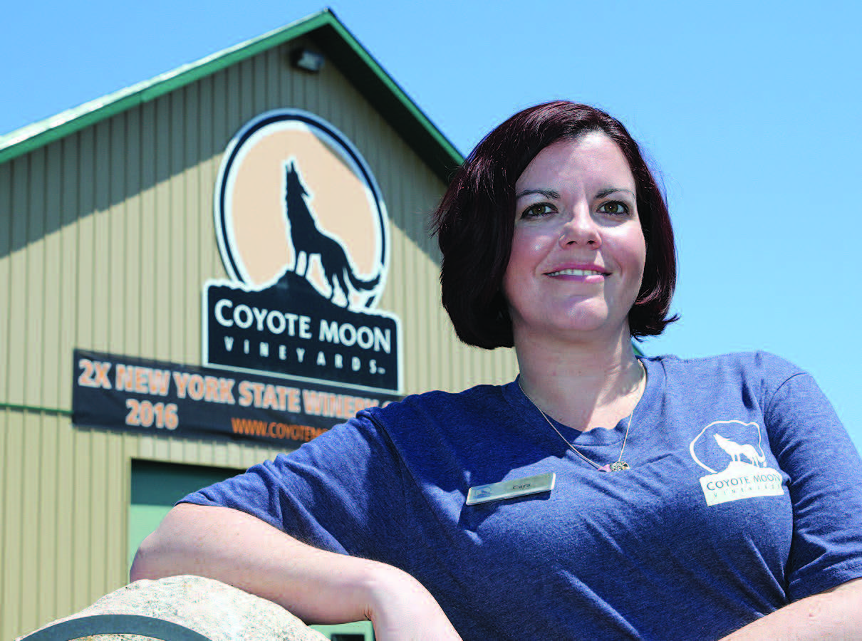 JCC Student posing for photo in front of Coyote Moon Vineyards building