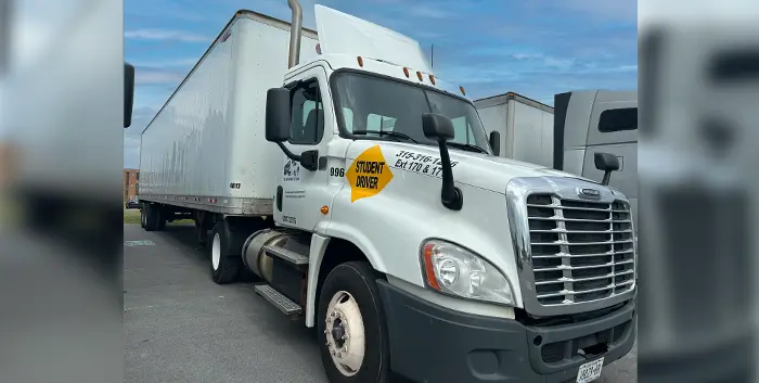 18 wheeler with student driver sign