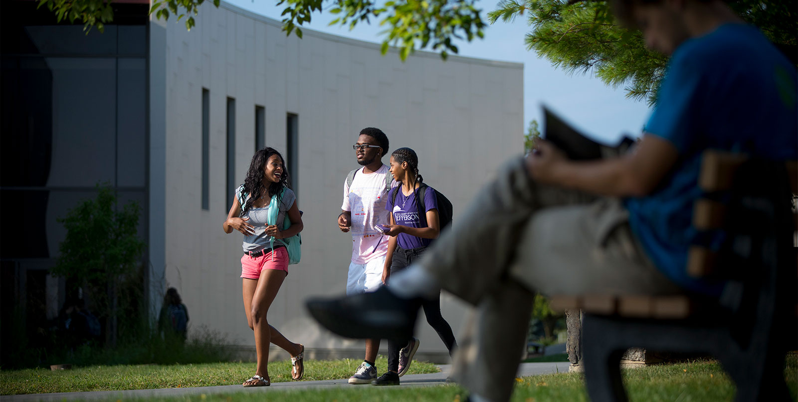 Students walking on campus on a sunny day