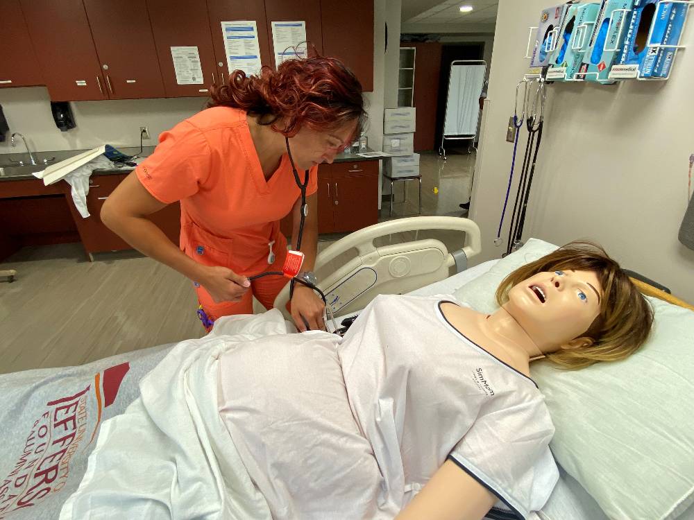 Image of nursing student working with new manikin