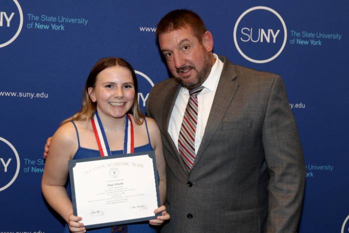 Paige Schultz with Administrator-in-charge Dan Dupee, II. 