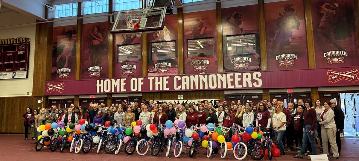 Group shot of JCC faculty and staff with 20 newly built bicycles set for donation