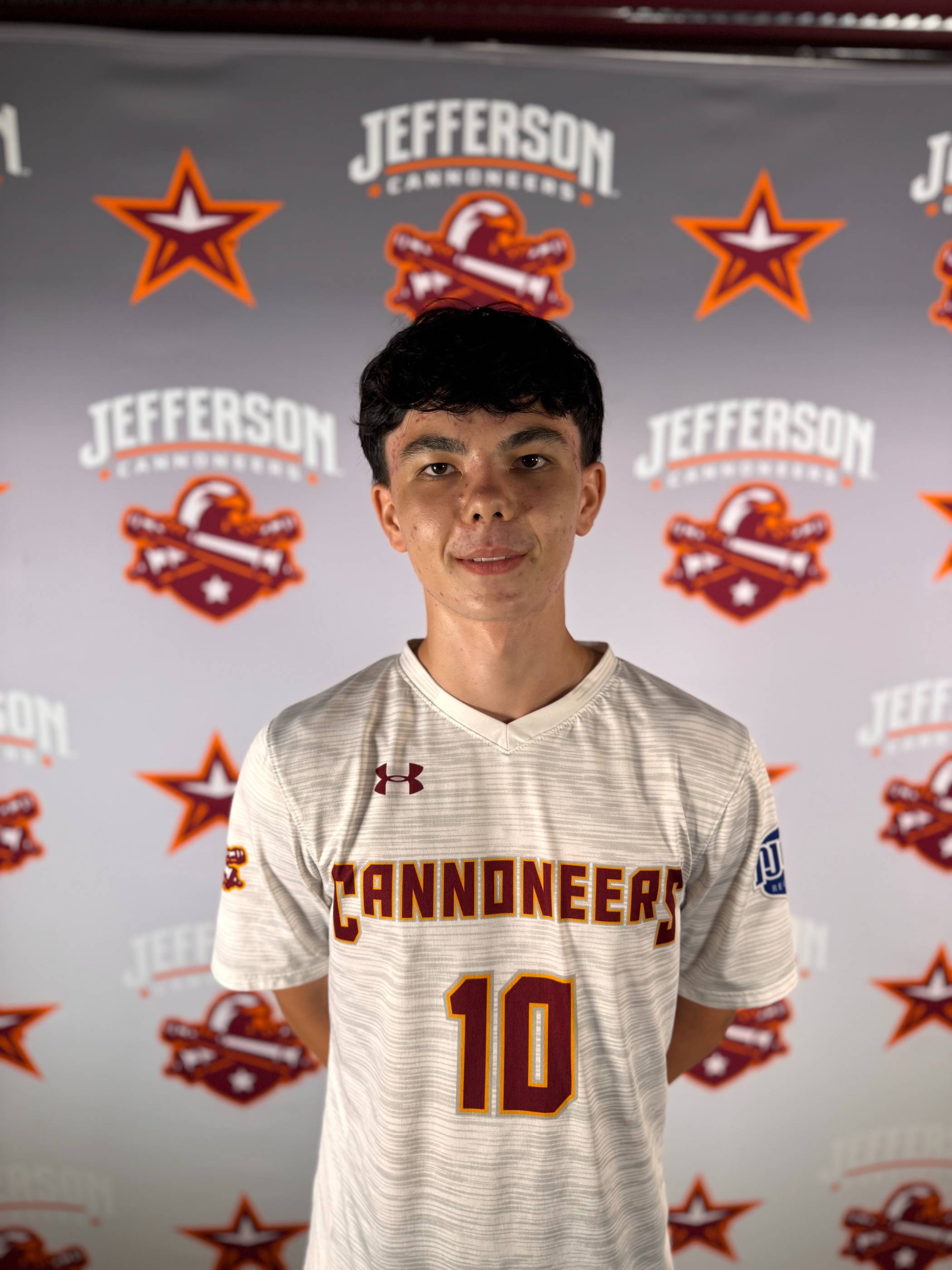 Image of student athlete posing in front of a backdrop